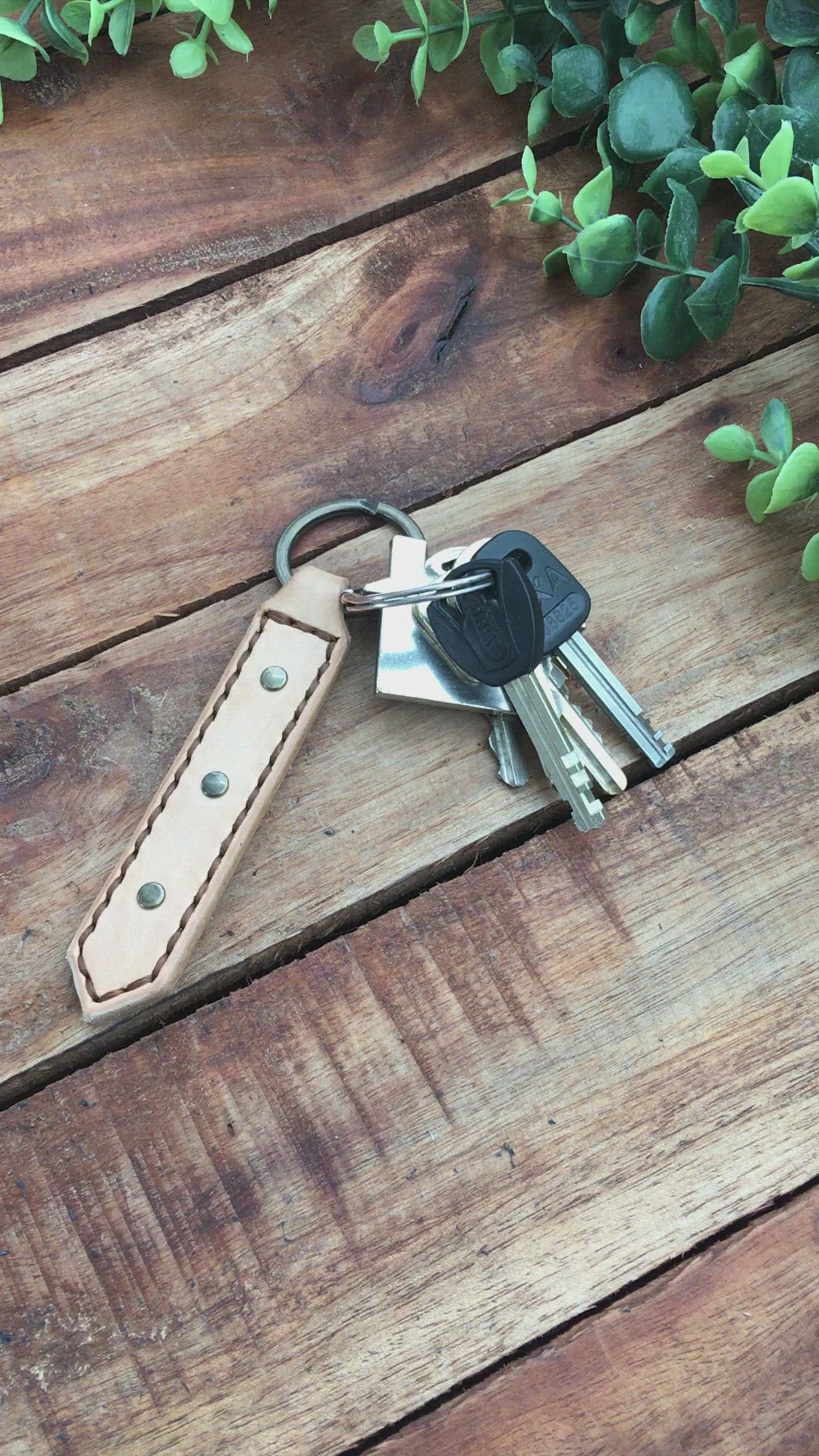 Video Showing a Handmade Natural Undyed Leather Studded Keychain with Brown  Stitching