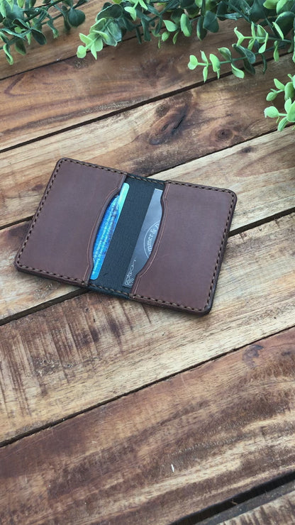 video showing the Handmade Two-tone Bifold Leather Card Wallet in Black and Brown with brown stitching