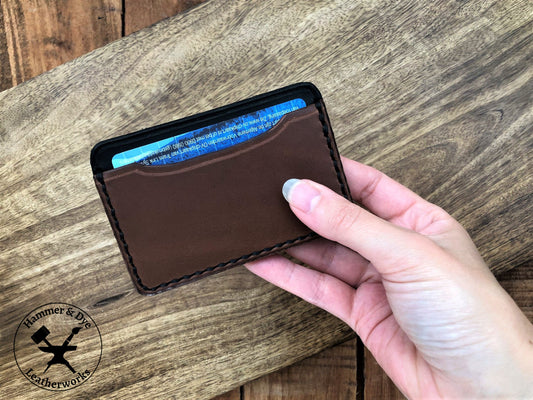 Minimalist Leather Card Wallet in Brown and Black in a hand