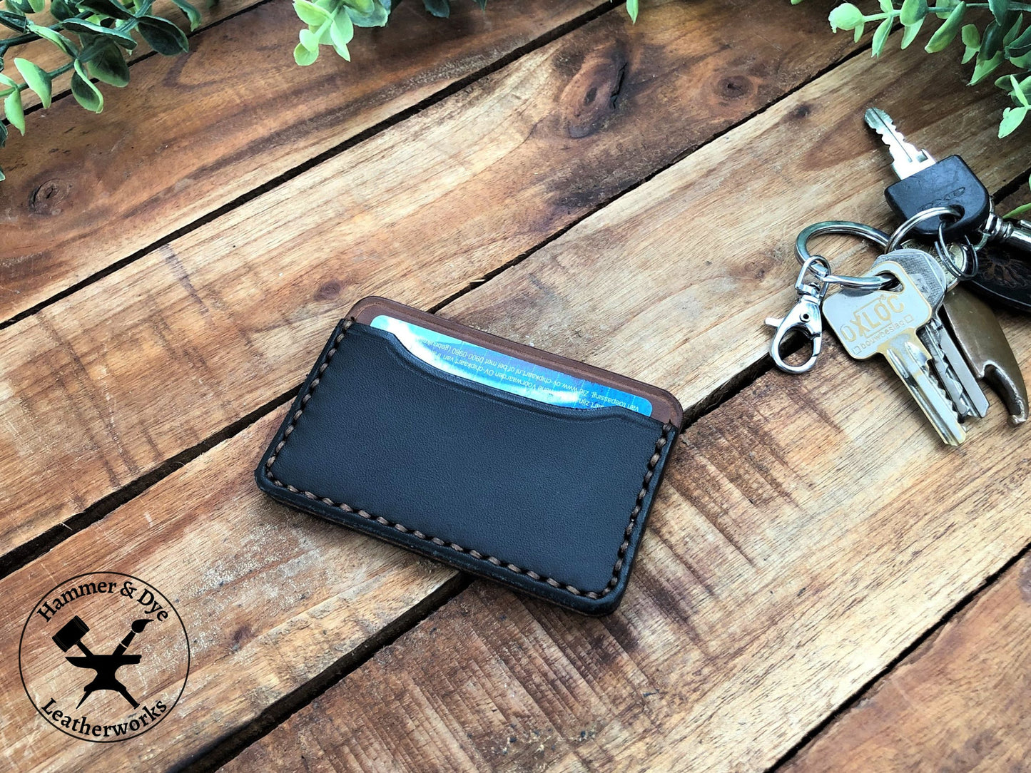Minimalist Leather Card Wallet in Black and Brown on a desk next to some keys