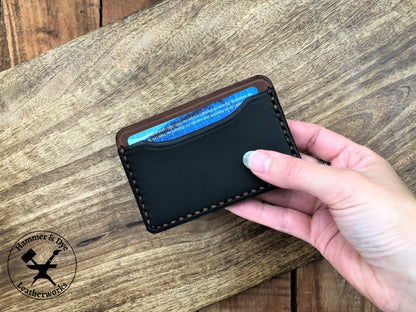 Minimalist Leather Card Wallet in Black and Brown in a hand