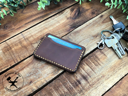 Handmade Minimalist Brown Leather Card Wallet with Hazel Stitching on a desk