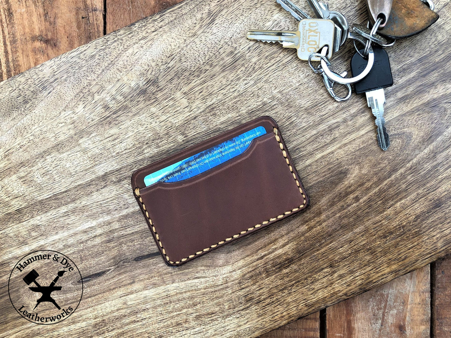 Handmade Minimalist Brown Leather Card Wallet with Hazel Stitching next to some keys