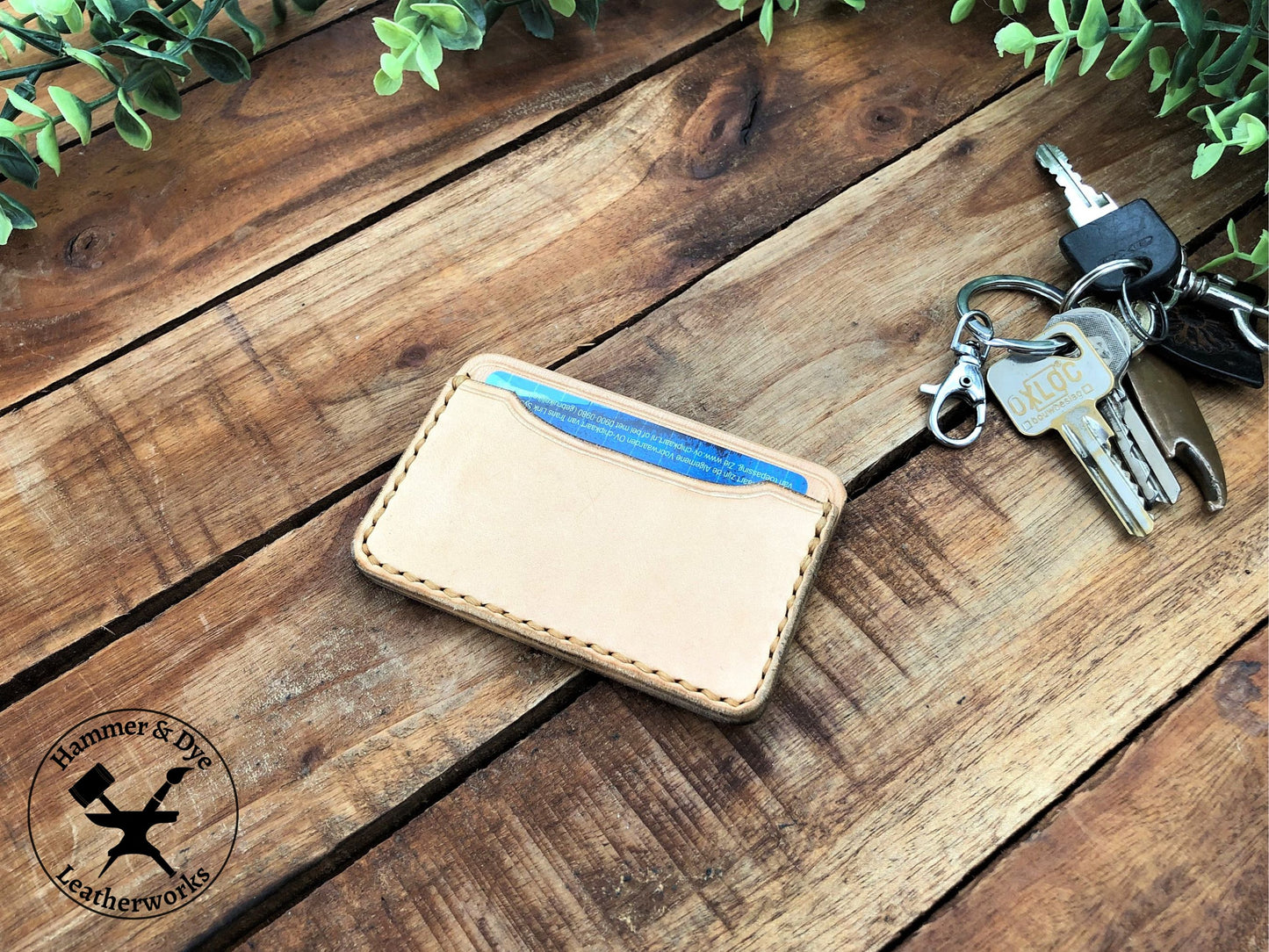 Handmade Minimalist Natural Leather Card Wallet with Hazel Stitching on a desk with keys