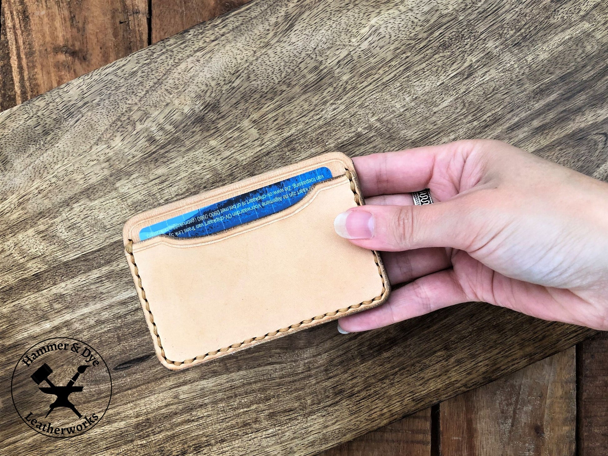 Handmade Minimalist Natural Leather Card Wallet with Hazel Stitching held in a hand
