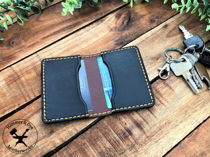 Handmade Two-tone Bifold Leather Card Wallet in Brown and Black with Hazel Stitching next to a bunch of keys
