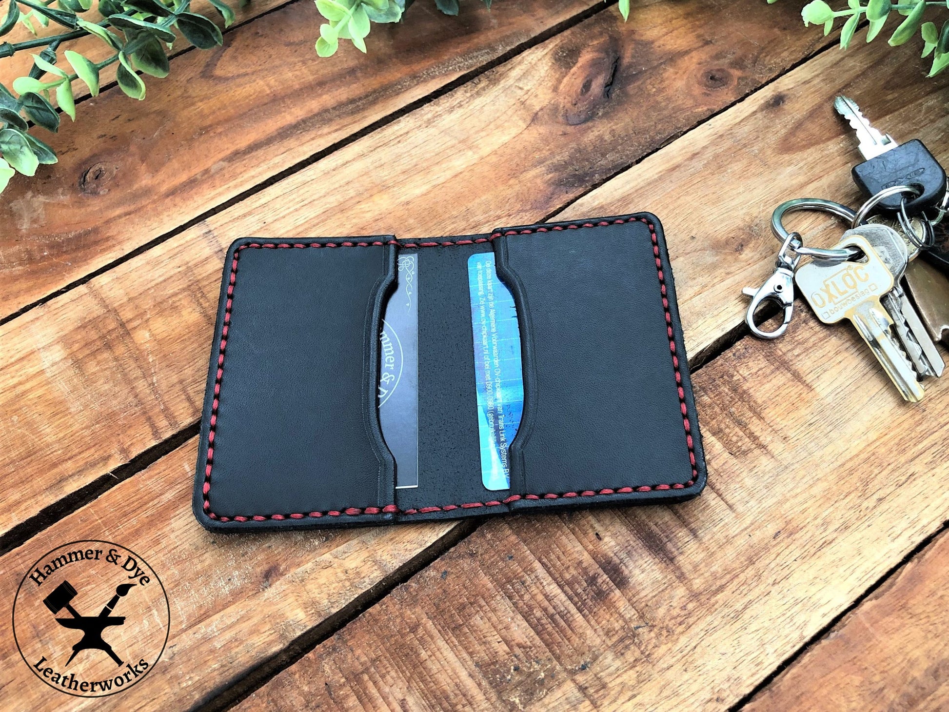 Handmade Black Bifold Leather Card Wallet on a desk next to some keys