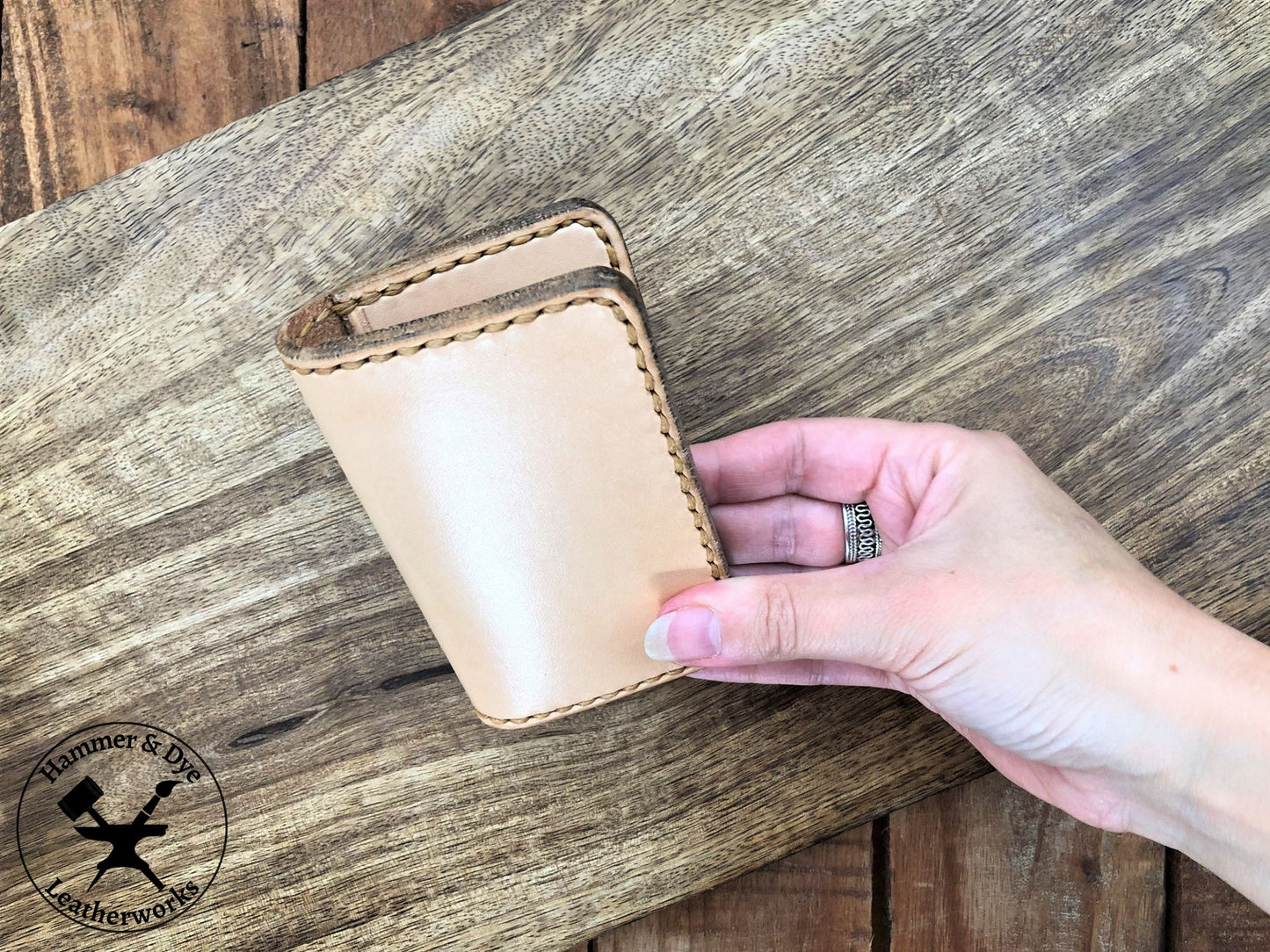 Handmade Natural Bifold Leather Card Wallet held in a hand