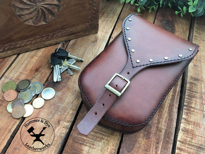 Styled image of a Large Handmade Brown Leather Belt Pouch with Buckle closing and Studs 