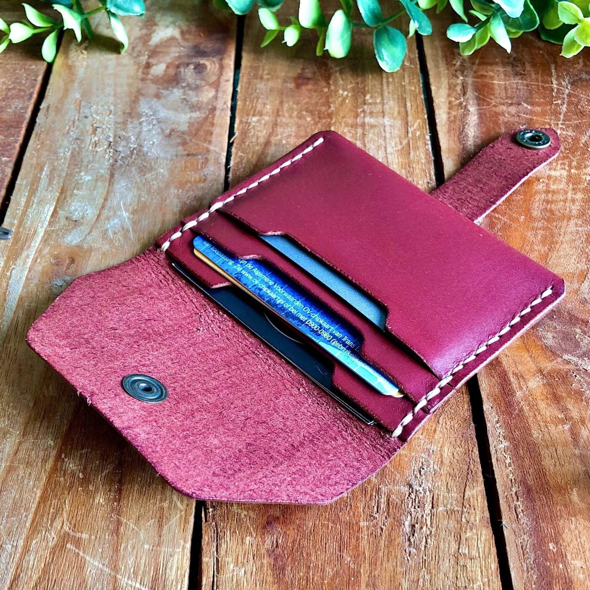 Small Wallet Bundle 4 Leather card wallet filled with cards on a wooden background