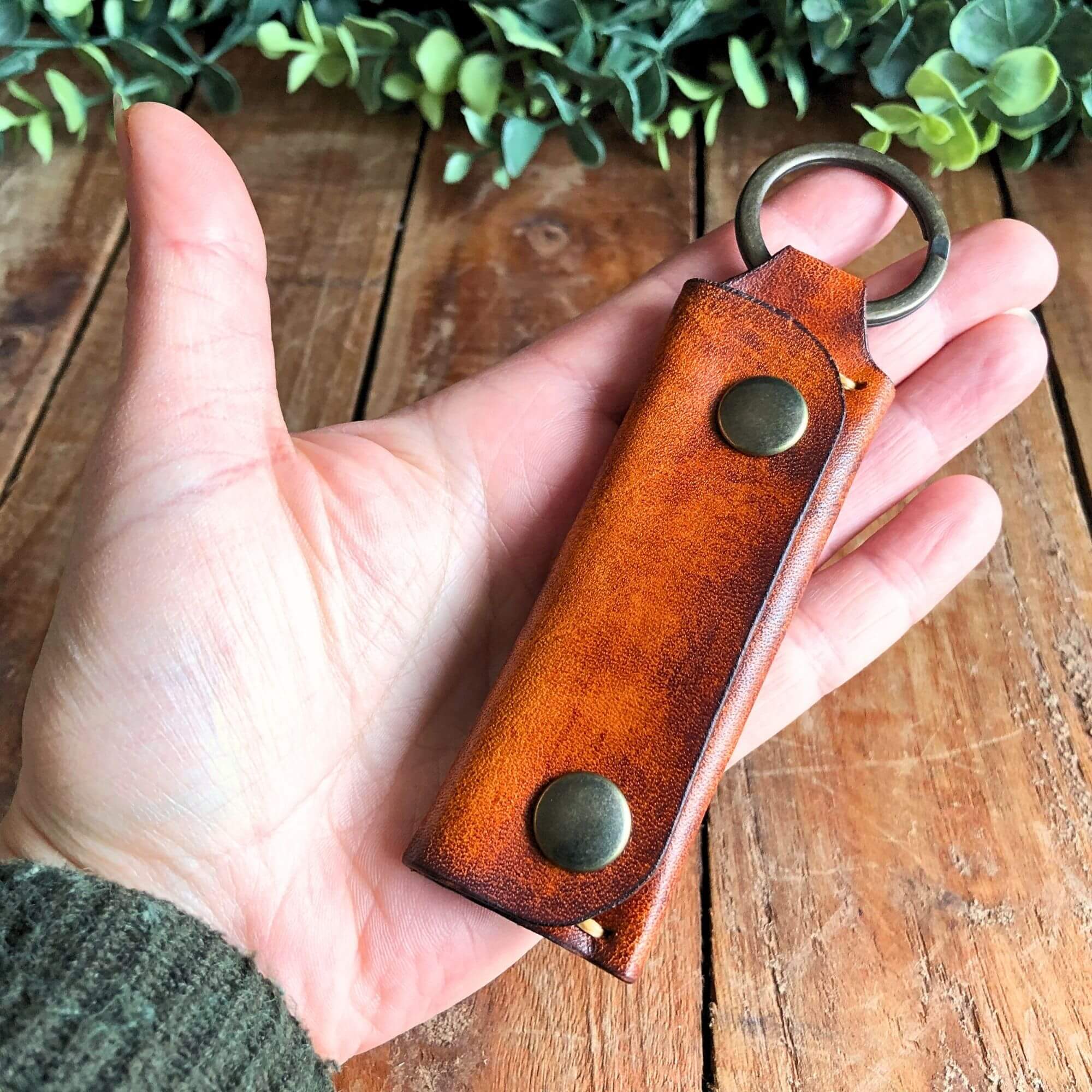 Emergency Keychain Wallet 5 brown mini keyring wallet held in hand