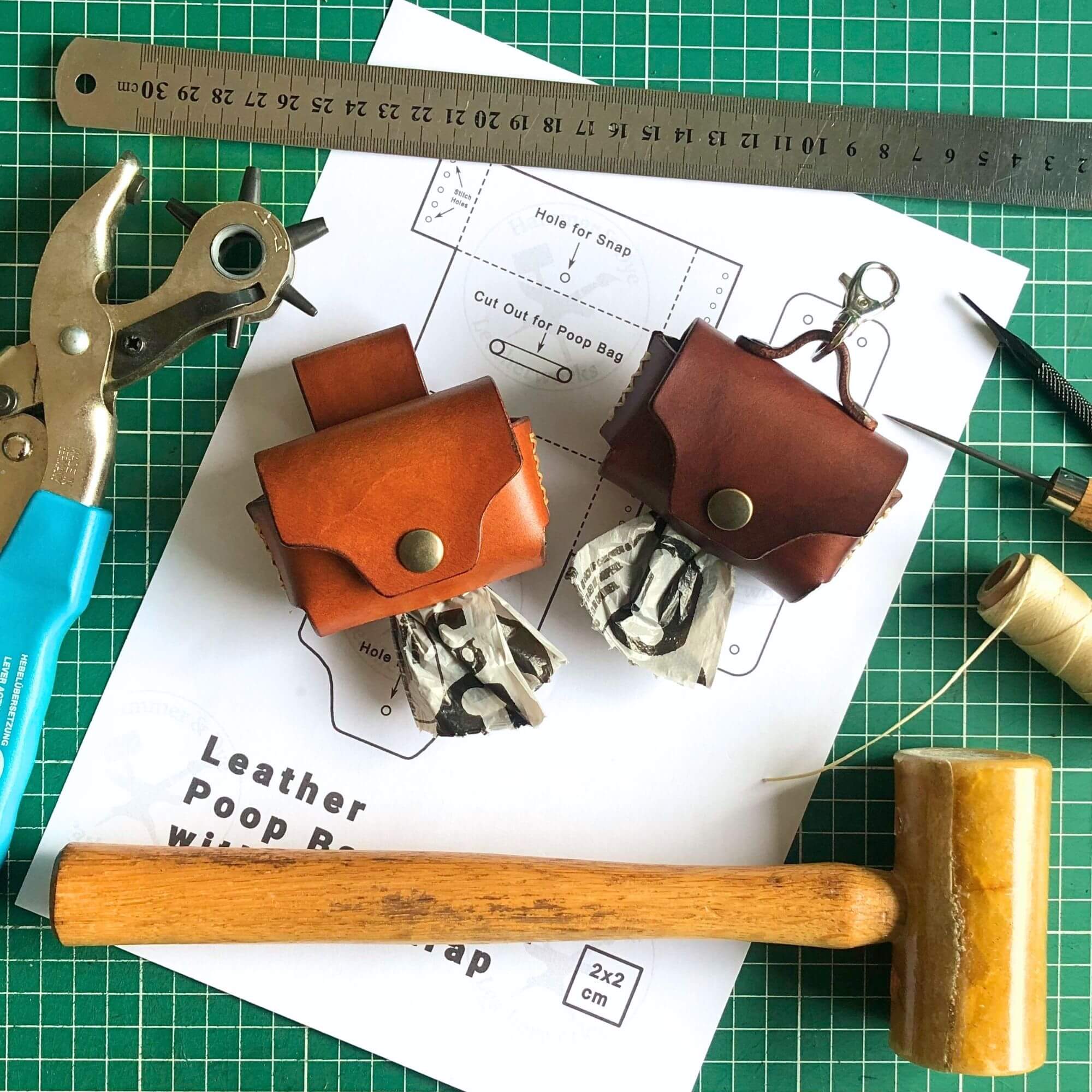 leather dog poop bag holder pattern surrounded by leathercraft tools and the finished product