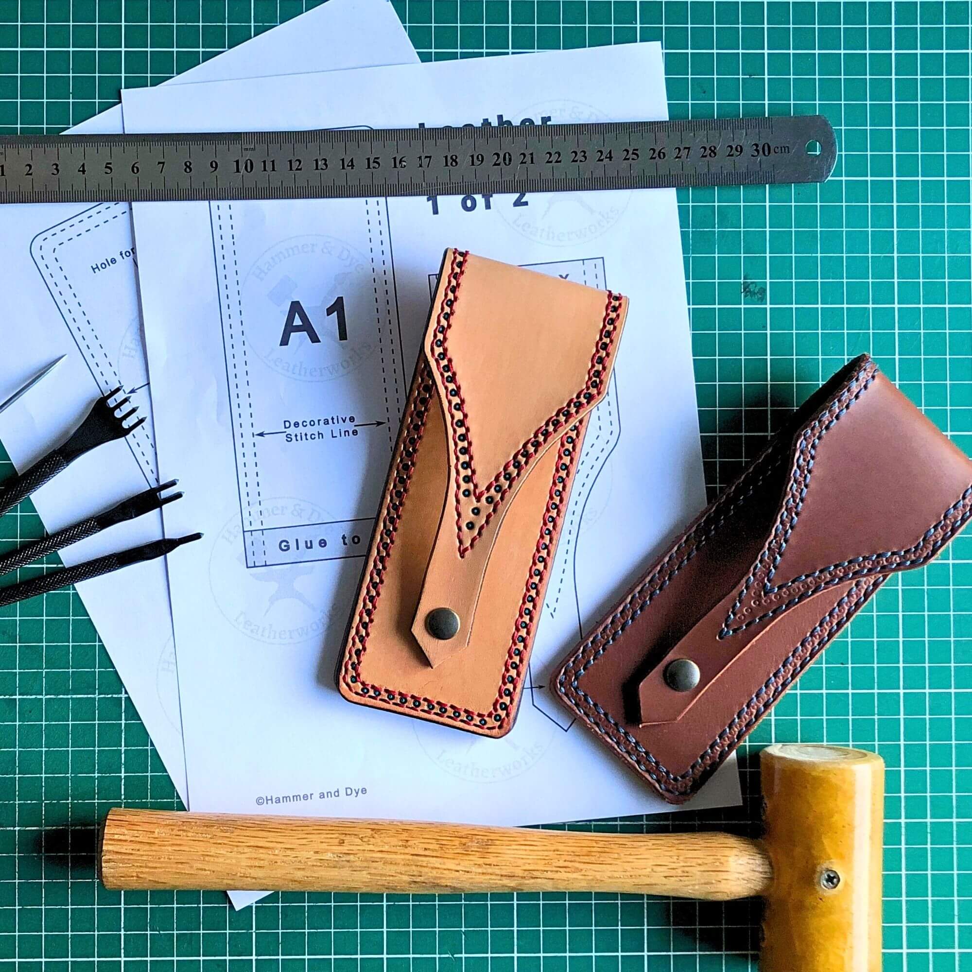 leathercraft pattern for a pen pouch surrounded by leathercraft tools and the finished pen pouch