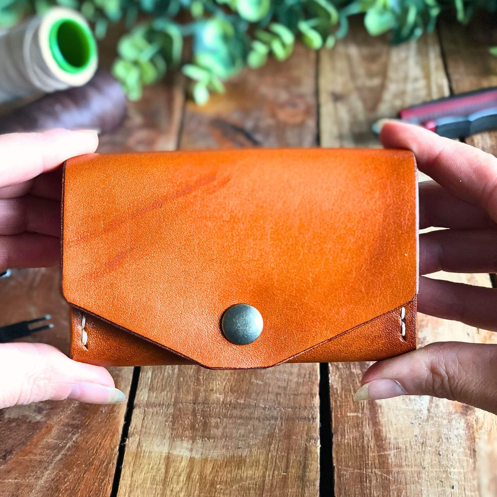 leather wallet with card and coin pocket held in two hands