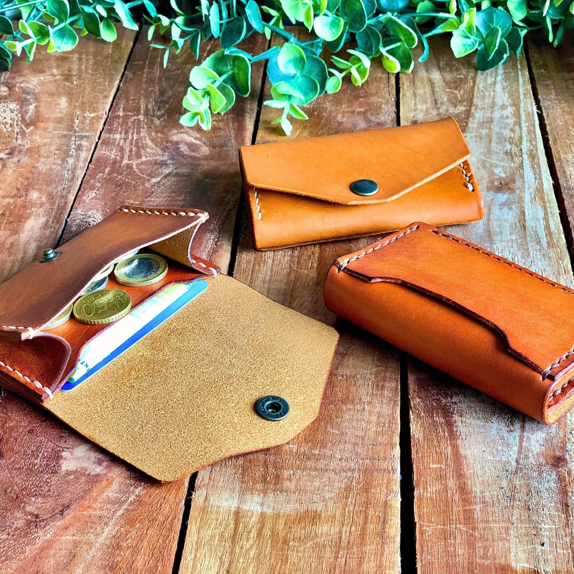 Small Wallet Bundle 2 3 leather wallets with card and coin pocket in tan color on a wooden background