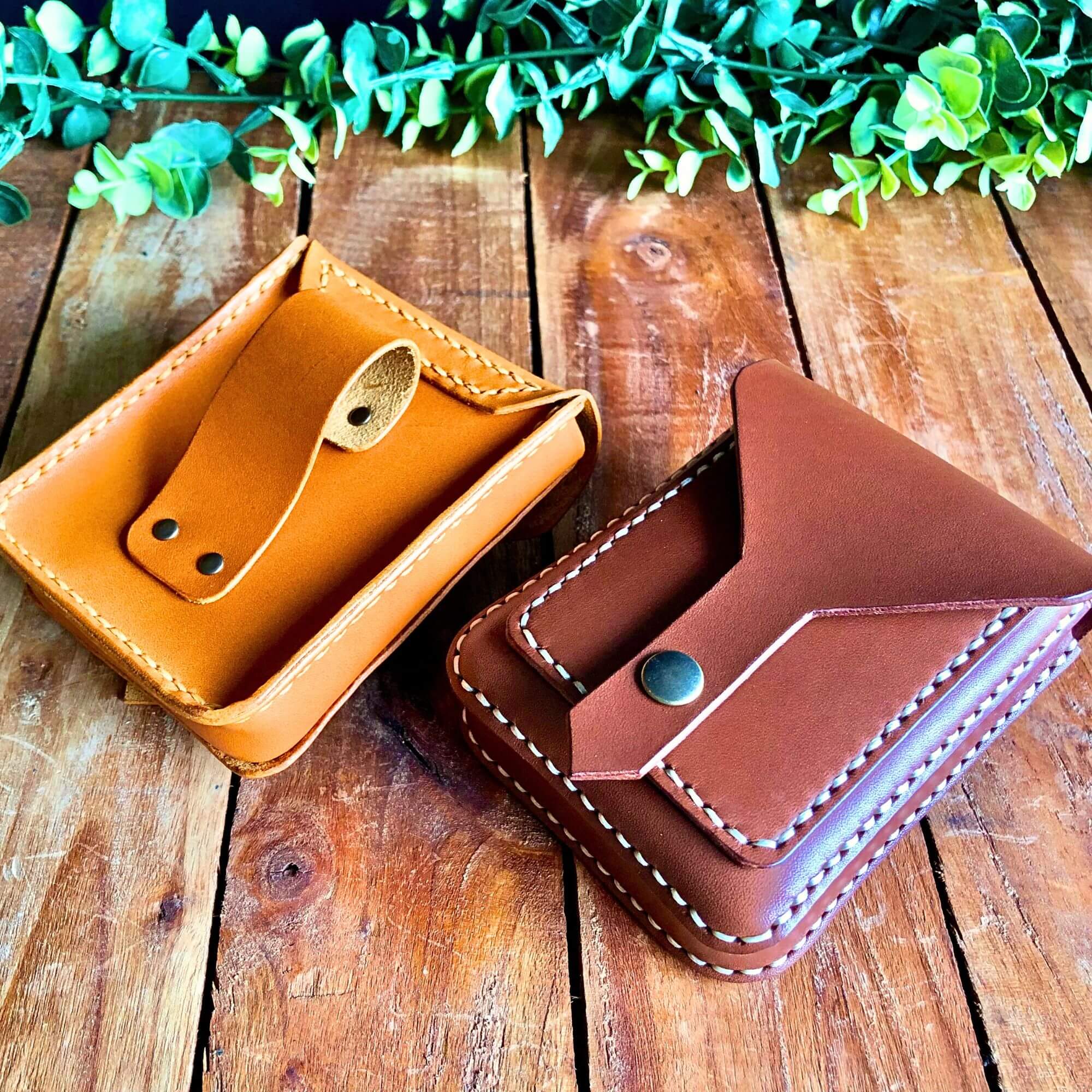 2 compact leather belt pouches with snap closing showing front and back
