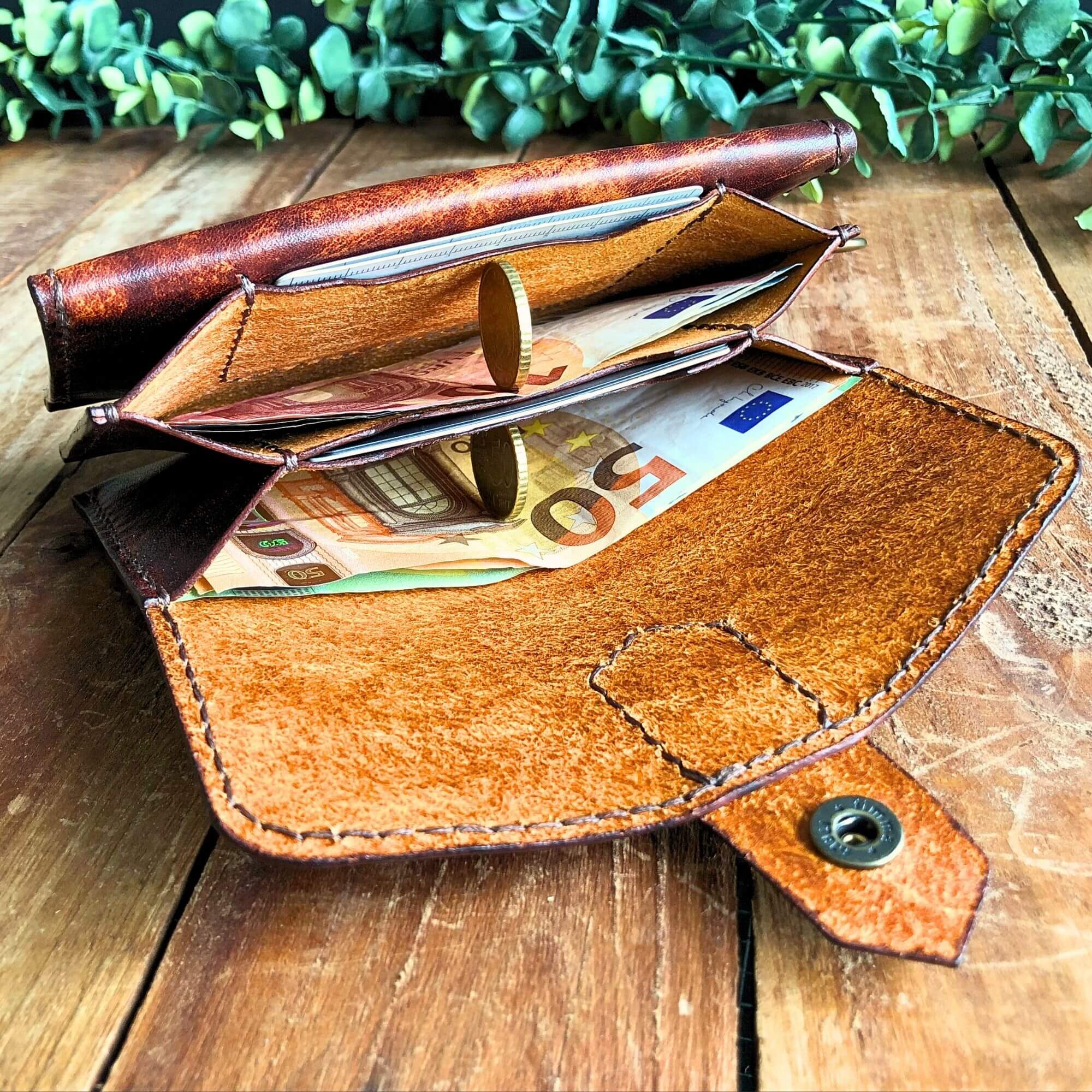 The dispatch wallet leather PDF pattern, finished wallet on a rustic wooden background