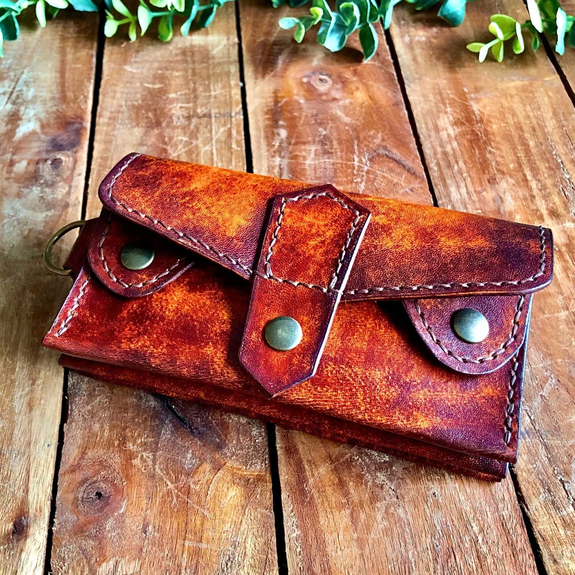 Handmade Leather Dispatch Wallet on a rustic wooden surface